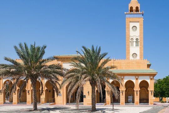 View to Sheikh Hamdan bin Mohammed Al Nahyan Mosque in typical moroccan style with majestic minaret and archways gallery, covered white arabesque mosaic tiles located in Abu Dhabi,UAE