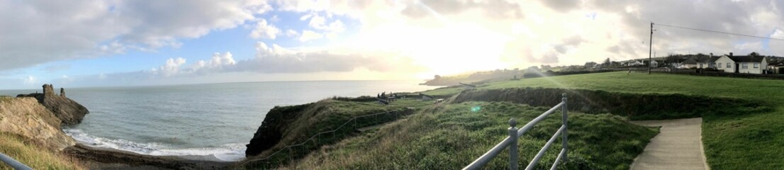 Panoramic coastal landscape with cliffs and ocean.
