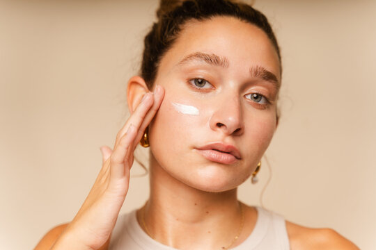 Female Model Applying Moisturizing Cream