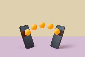 Two smartphones with orange balls bouncing between their screens