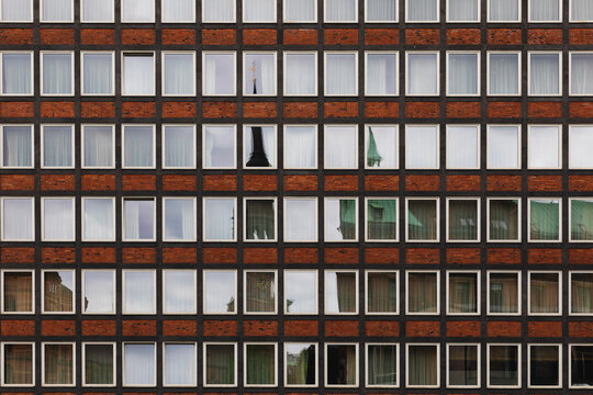 Symmetrical Windows with Reflections on a Brick Facade