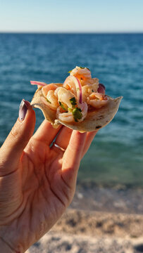 Shrimp tostada in hand
