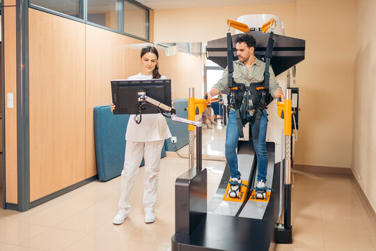 Patient on robotic treadmill therapy