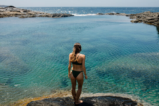 Bikini clad local lady admiring the scenery of Timanfaya National Park