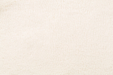 White cuddle teddy bear fabric as background, top view © Liami