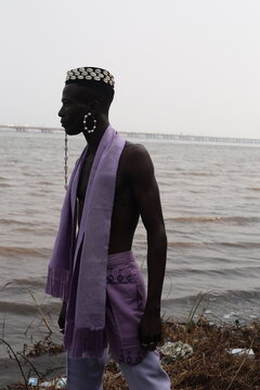  model wearing a hat filled with cowries shells