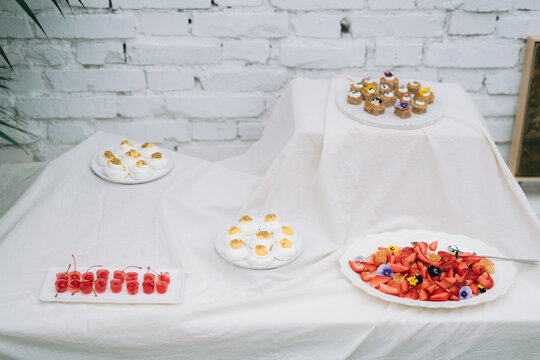 Assortment of plated food with deviled eggs and cherries