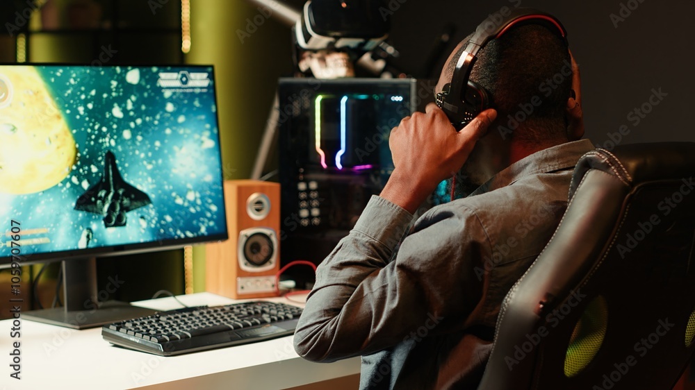 Aufkleber man playing sf shooter videogame on computer monitor, talking into headset with friends. gamer using