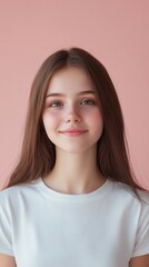 Fototapeta premium Young Woman with Long Hair Smiling Against a Pink Background