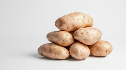 Fototapeta premium fresh potatoes against a white background, ideal for culinary, agricultural, and healthy eating content.