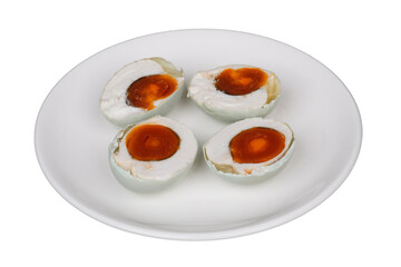 Half slices of hard-bolied salted duck eggs on a white plate isolated transparent