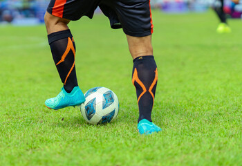 Soccer player prepares to strike soccer ball.