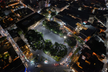 An enchanting aerial drone view of the Municipal Palace in Cuernavaca, Mexico, illuminated at night, showcasing the historic architecture and cityscape