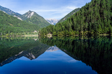 A tranquil lake nestled amidst a breathtaking mountain landscape. Jiuzhai Valley National Park, China