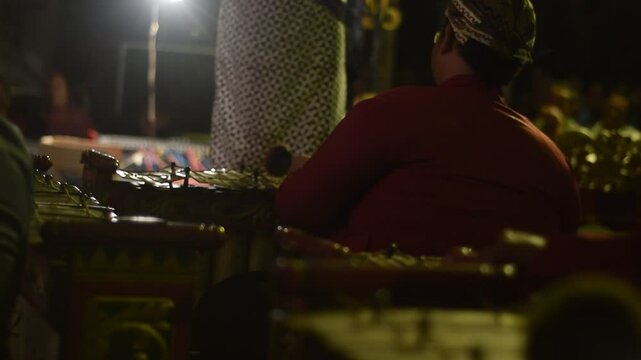 Close up man playing Gamelan, traditional instrumental from java indonesia at wayang or puppet theatre
