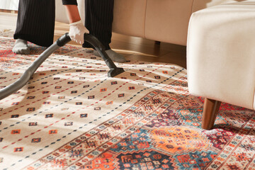 women cleaning a carpet with vacuum a cleaner,