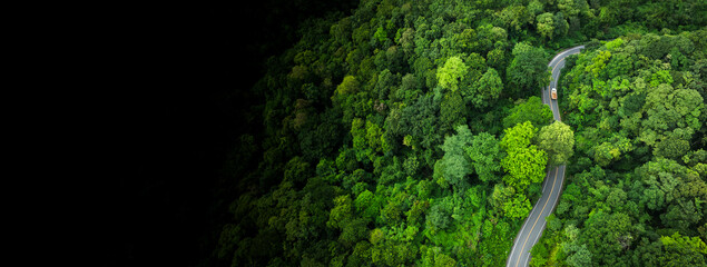 Aerial top view of car and truck driving on highway road in green forest , Sustainable transport. 