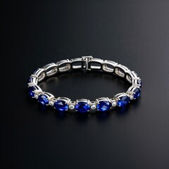 Art deco sapphire bracelet in white gold on plain black dark background