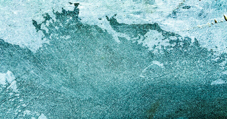 Abstract image of a teal textured surface with faded white patches. Classic, elegant and charming textured background photo for banner background.