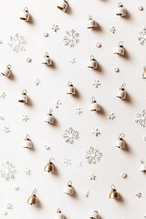 Fototapeta premium Flat lay of golden bells and snowflakes on white.