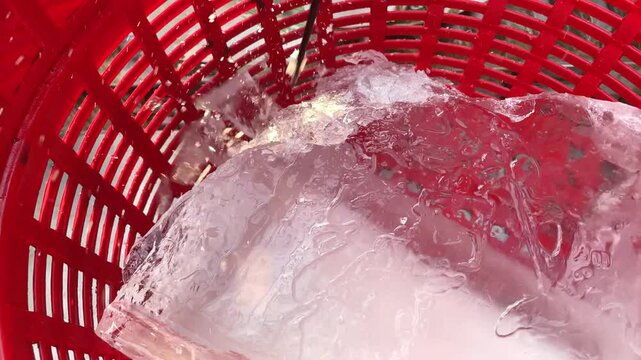 Unidentified people  hitting big ice with ice pick. Food industrial, Preparation concept.