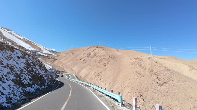 Driving on asphalt winding road passing through valley on sunny autumn day in Tashkurgan, Kashgar, Southern Xinjiang, China, POV from the car, 4k real time footage, travel concept.