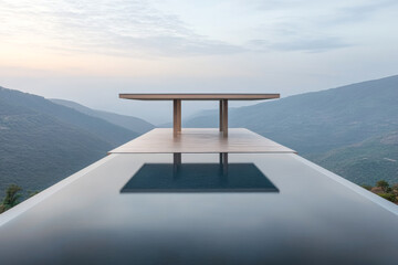 A modern table overlooking a breathtaking mountain vista at sunrise in a serene landscape