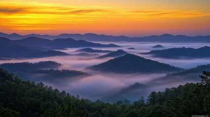 A stunning sunrise over a mountain range with a sea of fog flowing through the valleys.