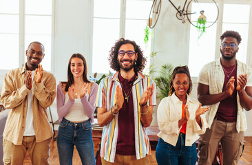 Diverse group standing and clapping