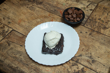 black forest cake with vanilla ice cream at the top of the dark chocolates and having cubes of chocolate in black cups