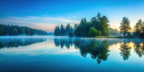 Obraz premium A serene lake at dawn with a teal blue water surface reflecting the surrounding trees and misty atmosphere, lake, scenery