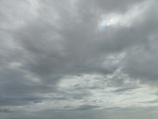 Obraz premium Dramatic dark storm rain clouds black sky background.Dark thunderstorm clouds rainny atmosphere.Meteorology danger windstorm disasters climate.Dark cloudscape storm disaster gloomy gray cloud sky.