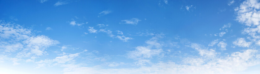 Fototapeta premium A blue sky with white clouds. The sky is clear and bright, and the clouds are scattered throughout the sky.
