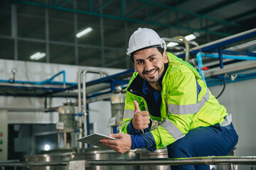 Portrait of satisfied happy smiling factory manager. Engineer wearing safety vest standing service...