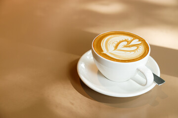 Cup of hot latte coffee on table