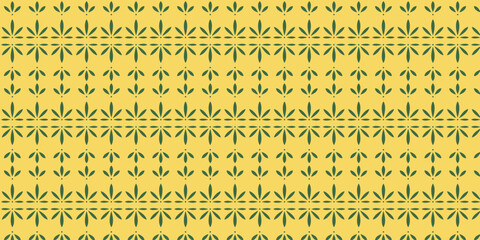 Seamless pattern with green cassava leaf motif on yellow background