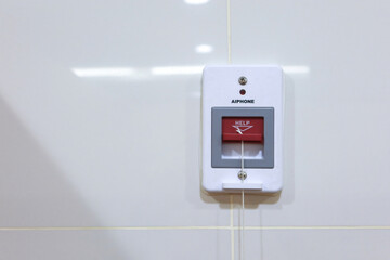 Emergency call button on wall, designed for assistance requests