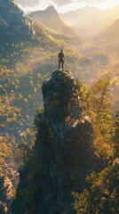 Fototapeta premium Man Standing on Cliff Overlooking Breathtaking Sunset Valley