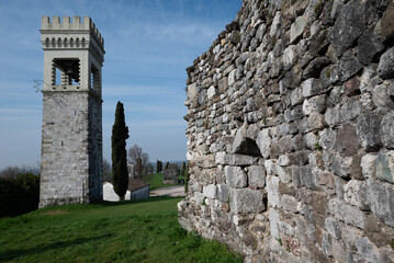 The clock tower of the ancient castle of Fagagna in Friuli (Italy) from behind with christmas falling star led decoration