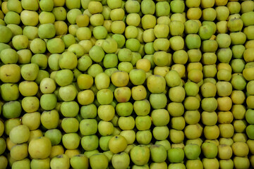 Lots of green apples, Background of apples, Lot of organic Green apples at market. Healthy food, lifestyle concept, Top view of a lot of apples, Tray farmer's market.
