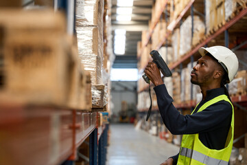 Warehouse staff member checking inventory with barcode scanner