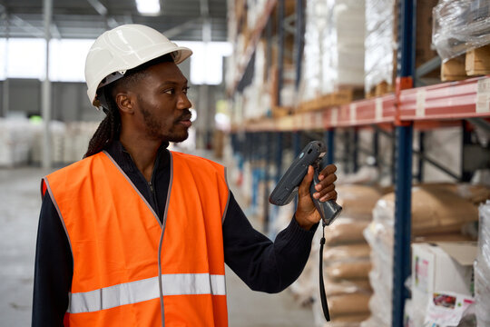 Warehouse worker scanning packages with barcode scanner