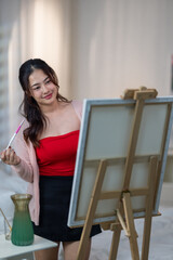 Obraz premium Woman Painting at Home Studio