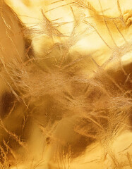 Elegant gold foil texture with distressed finish for luxury design. Abstract grunge metallic surface with scratches and smudges. Versatile golden backdrop for creative projects in fashion