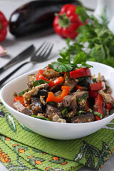 Warm salad with tongue, eggplant and sweet pepper in white plate © Anzhela