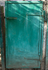 Close-up of the old green metal gate