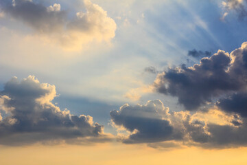 Sky with a mix of dark and light clouds illuminated by a warm, low sun. Represents dramatic weather...