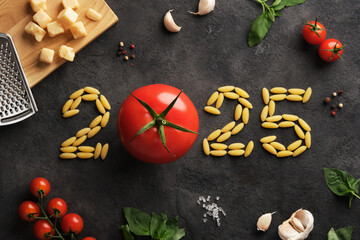 2025 figures with Italian ingredients on dark stone background, tomatoes, pasta, basil and parmesan