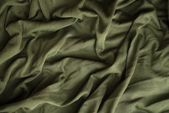 Background texture of camouflage khaki green color military uniform fabric