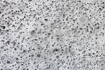 Basalt stone background .Basalt is a common extrusive igneous (volcanic) rock formed from the rapid cooling of basaltic lava exposed at or very near the surface of a planet or moon.
